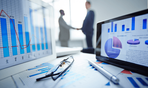 Business dashboards and colleagues discussing a growth plan